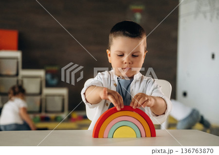 Rainbow toy game. Group of children are in the kindergarten 136763870