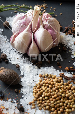 seasonings background with salt, Spices and garlic served at black. natural meal additives. healthy food concept. macro shot seasonings background with salt, Spices and garlic served at black. natural meal additives. healthy food concept. macro shot 136764113