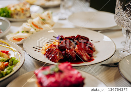 Grilled beef steak with berry sauce and potatoes served in elegant restaurant setting Grilled beef steak with berry sauce and potatoes served in elegant restaurant setting 136764375