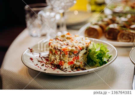 Olivier salad served as festive appetizer on restaurant table 136764381