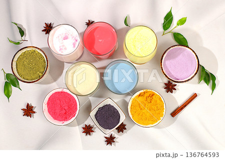 Various matcha tea lattes with milk on light background and matcha powder in cups. Traditional Indian trendy drink rich in antioxidants, used for weight loss and treatment, selective focus. Various matcha tea lattes with milk on light background and matcha powder in cups. Traditional Indian trendy drink rich in antioxidants, used for weight loss and treatment, selective focus. 136764593