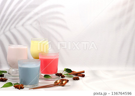 Assortment of different matcha chai lattes with milk on elegant kitchen sunny background and matcha powder. Traditional Indian drink rich in antioxidants, used for weight loss and treatment, . Assortment of different matcha chai lattes with milk on elegant kitchen sunny background and matcha powder. Traditional Indian drink rich in antioxidants, used for weight loss and treatment, . 136764596