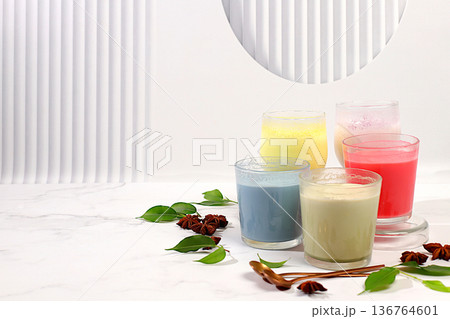 Assortment of different matcha chai lattes with milk on elegant kitchen sunny background and matcha powder. Traditional Indian drink rich in antioxidants, used for weight loss and treatment, . 136764601