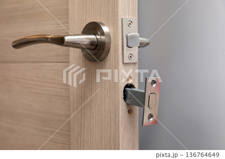 Installing a new door handle, closeup shot Installing a new door handle, closeup shot 136764649