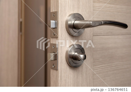 Installing a new door handle, closeup shot. Installing a new door handle, closeup shot. 136764651