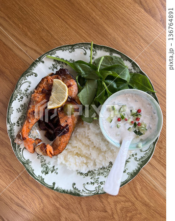 Healthy salmon meal with rice, spinach, and tzatziki Healthy salmon meal with rice, spinach, and tzatziki 136764891