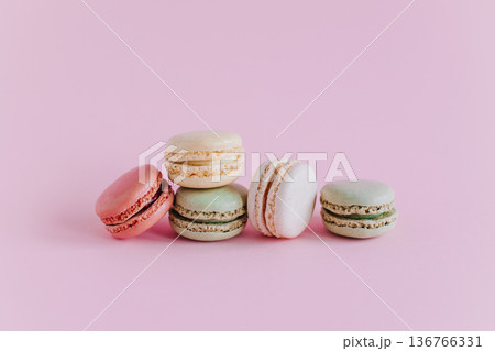 Tasty french macarons on a pink pastel background. 136766331