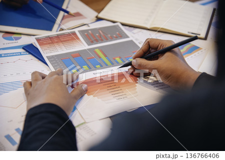 Two businesspeople meeting work at office desk. Teamwork partners team with Business strategy chart graph, infographic data financial report. Team partner planning marketing finance excel stat report 136766406