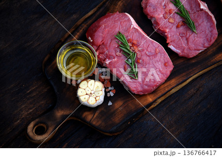 Top view raw beef tender meat steak grill pork barbeque on wooden board. Steak western cuisine ingredient fresh herb meat pepper olive oil garlic chilli tomato salt rosemary on wood plate outdoor. 136766417