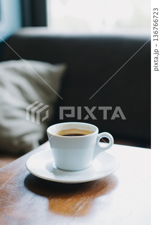 Cup of black coffee on a table in a cafe. Selective focus. Cup of black coffee on a table in a cafe. Selective focus. 136766723