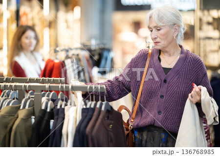 Elderly woman choosing a coat in a store 136768985