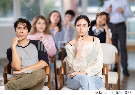Group of young students listening during seminar in a modern classroom 136769072