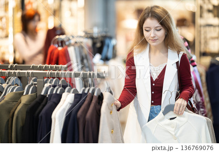 European woman chooses a warm coat 136769076