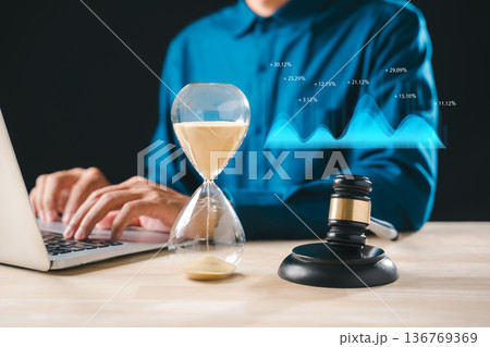 Hourglass, legal gavel, clock timer, time deadline, justice concept, professional working laptop, managing critical law matters, analyzing financial growth data Hourglass, legal gavel, clock timer, time deadline, justice concept, professional working laptop, managing critical law matters, analyzing financial growth data 136769369