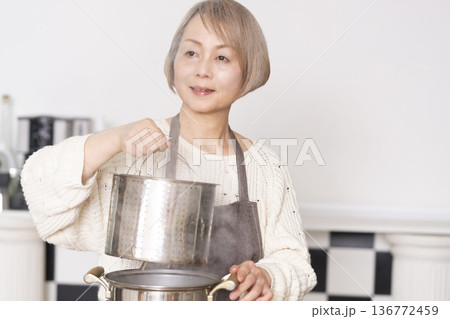 キッチンでパスタを茹でるシニア女性 136772459