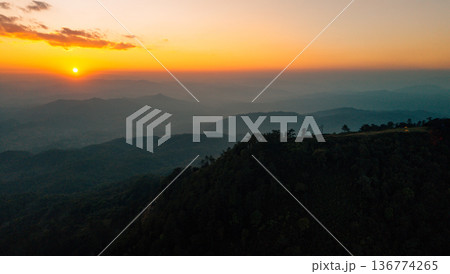 Breathtaking aerial landscape of layered mountains silhouette at golden hour sunset. Breathtaking aerial landscape of layered mountains silhouette at golden hour sunset. 136774265