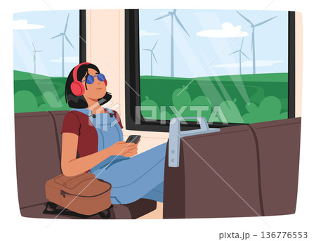 Young Woman Listening To Music With Headphones While Riding The Train. She Appears Lost In Her Own World 136776553