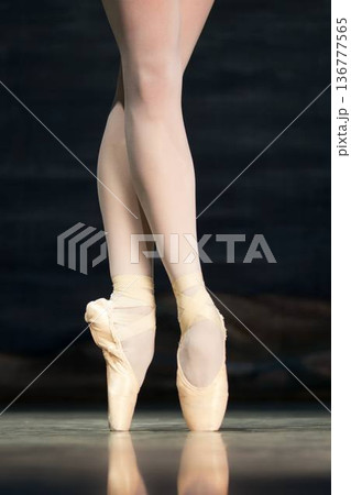 Ballet dancers legs en pointe in satin shoes  136777565