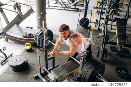 Strong man is working out in the gym Strong man is working out in the gym 136779573