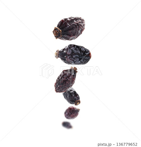 Dried rosehip berries levitate on a white background Dried rosehip berries levitate on a white background 136779652