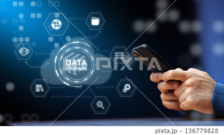 Person holding smartphone using data storage technology in a digital environment Person holding smartphone using data storage technology in a digital environment 136779828