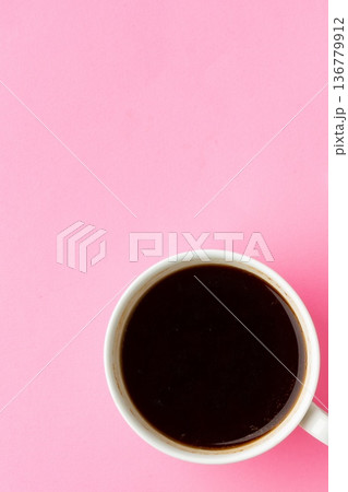 Black coffee in a white cup on a pink background during daylight hours Black coffee in a white cup on a pink background during daylight hours 136779912