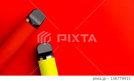 Lighters in red background showing two bright colors side by side on the surface 136779915