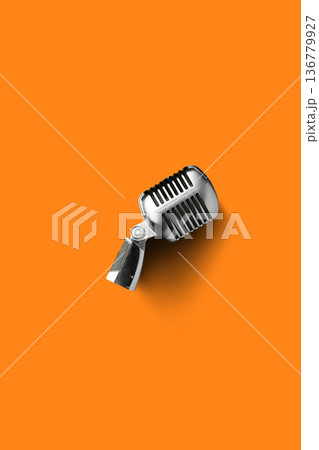 Podcast microphone on orange background ready for recording conversations and discussions 136779927