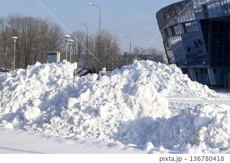 Huge snowdrifts in the parking lot 136780418