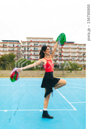 Cheerleader Girl Cheers Her Team On The Basketball Court 136780800