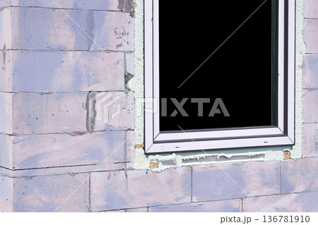 Construction.Metal plastic window on purple brick wall Construction.Metal plastic window on purple brick wall 136781910