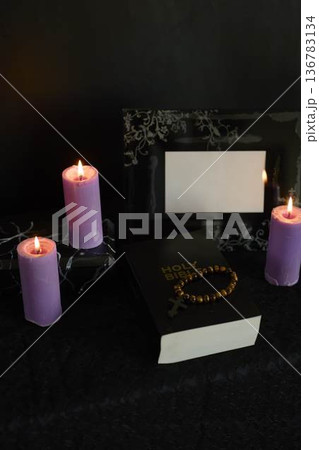 funeral, a photo frame, candles, marble urn for ashes, holy bible and spiritual bracelet with black cross funeral, a photo frame, candles, marble urn for ashes, holy bible and spiritual bracelet with black cross 136783134