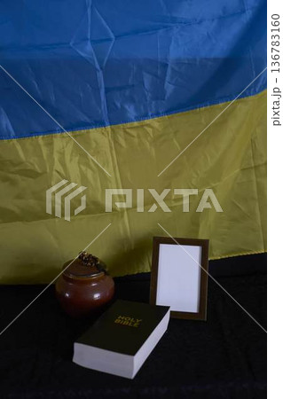 funeral of Ukrainian , photo frame, candles, marble urn for ashes, holy bible and acspiritual bracelet with black cross 136783160
