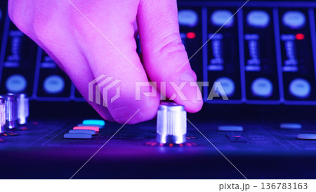 Audio Technician, Sound Engineer Adjusting Control Knob, Managing Sound Levels On Digital Mixing Console, Professional Audio Technology Concept Audio Technician, Sound Engineer Adjusting Control Knob, Managing Sound Levels On Digital Mixing Console, Professional Audio Technology Concept 136783163