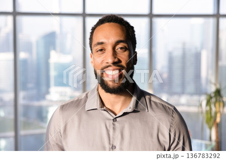 Happy handsome African American business leader man posing in office 136783292