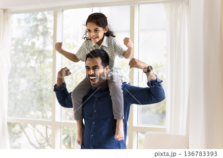 Kid and father screaming and showing strongman pose indoors Kid and father screaming and showing strongman pose indoors 136783393