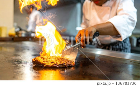 A skilled chef works over the intense heat of a kitchen forge, preparing meat over a burning coal flame where the craft of a blacksmith meets the industry of a professional grill A skilled chef works over the intense heat of a kitchen forge, preparing meat over a burning coal flame where the craft of a blacksmith meets the industry of a professional grill 136783730