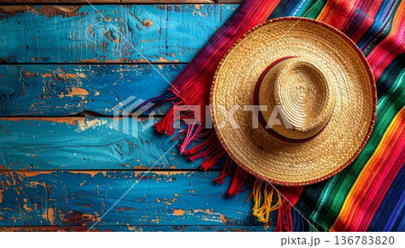 A fashionable woman wears a colorful mexican straw hat as a sun accessory for summer beach clothing A fashionable woman wears a colorful mexican straw hat as a sun accessory for summer beach clothing 136783820