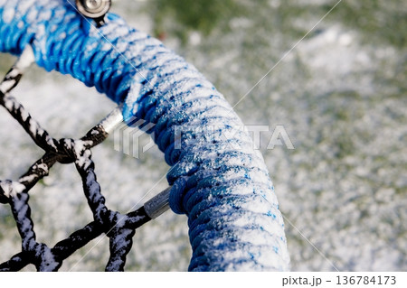 Snowy morning scene with vibrant blue goal net in winter sports field 136784173