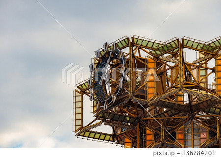 Exploration of a unique architectural structure with vibrant colors under a cloudy sky Exploration of a unique architectural structure with vibrant colors under a cloudy sky 136784201