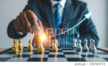 A successful businessman holding a trophy and a growth graph leads his team to checkmate in a strategic battle on the chessboard 136784751