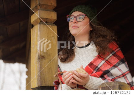 Cozy moments by the cabin with warm treats and peaceful thoughts on a chilly day 136785173