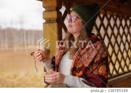 Warm moments of serenity while sipping tea on a chilly autumn day in a cozy countryside setting Warm moments of serenity while sipping tea on a chilly autumn day in a cozy countryside setting 136785189