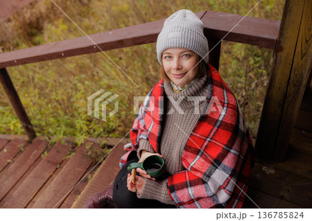Cozy moments by the porch during a quiet autumn afternoon in a serene woodland setting Cozy moments by the porch during a quiet autumn afternoon in a serene woodland setting 136785824