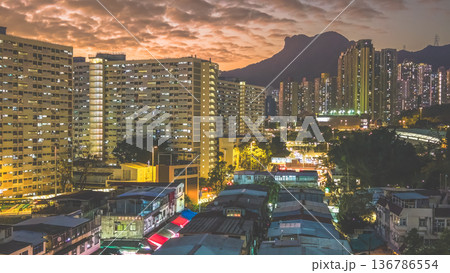 Night market walkway glowing beneath towering city skyline Feb 5 2026 136786554