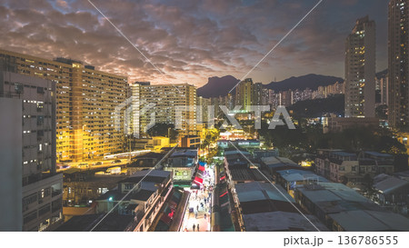 Night market walkway glowing beneath towering city skyline Feb 5 2026 136786555