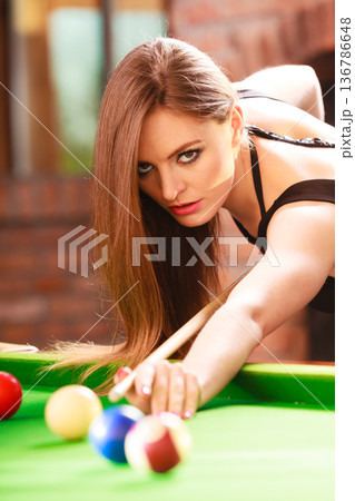 Young fashionable girl playing billiard. Young fashionable girl playing billiard. 136786648