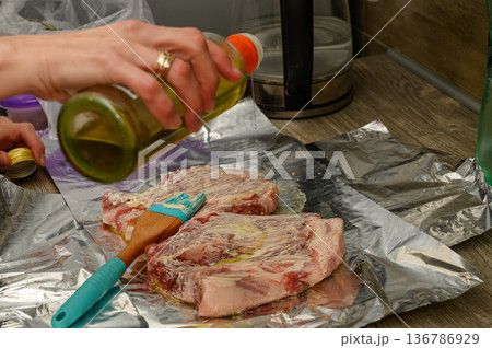 Preparing Herb and Garlic Marinade for Lamb Chops on Foil 136786929