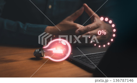 Concept of low energy or stalled creativity showing hands near a laptop with a glowing light bulb at 0%, symbolizing burnout, lack of ideas, motivation drain, productivity decline, and mental Concept of low energy or stalled creativity showing hands near a laptop with a glowing light bulb at 0%, symbolizing burnout, lack of ideas, motivation drain, productivity decline, and mental 136787146