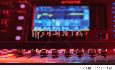 Mixing Console Faders In Foreground Close Up, Blurred Equalizer Screen In Background, Music Production Technology Copy Space Mixing Console Faders In Foreground Close Up, Blurred Equalizer Screen In Background, Music Production Technology Copy Space 136787158